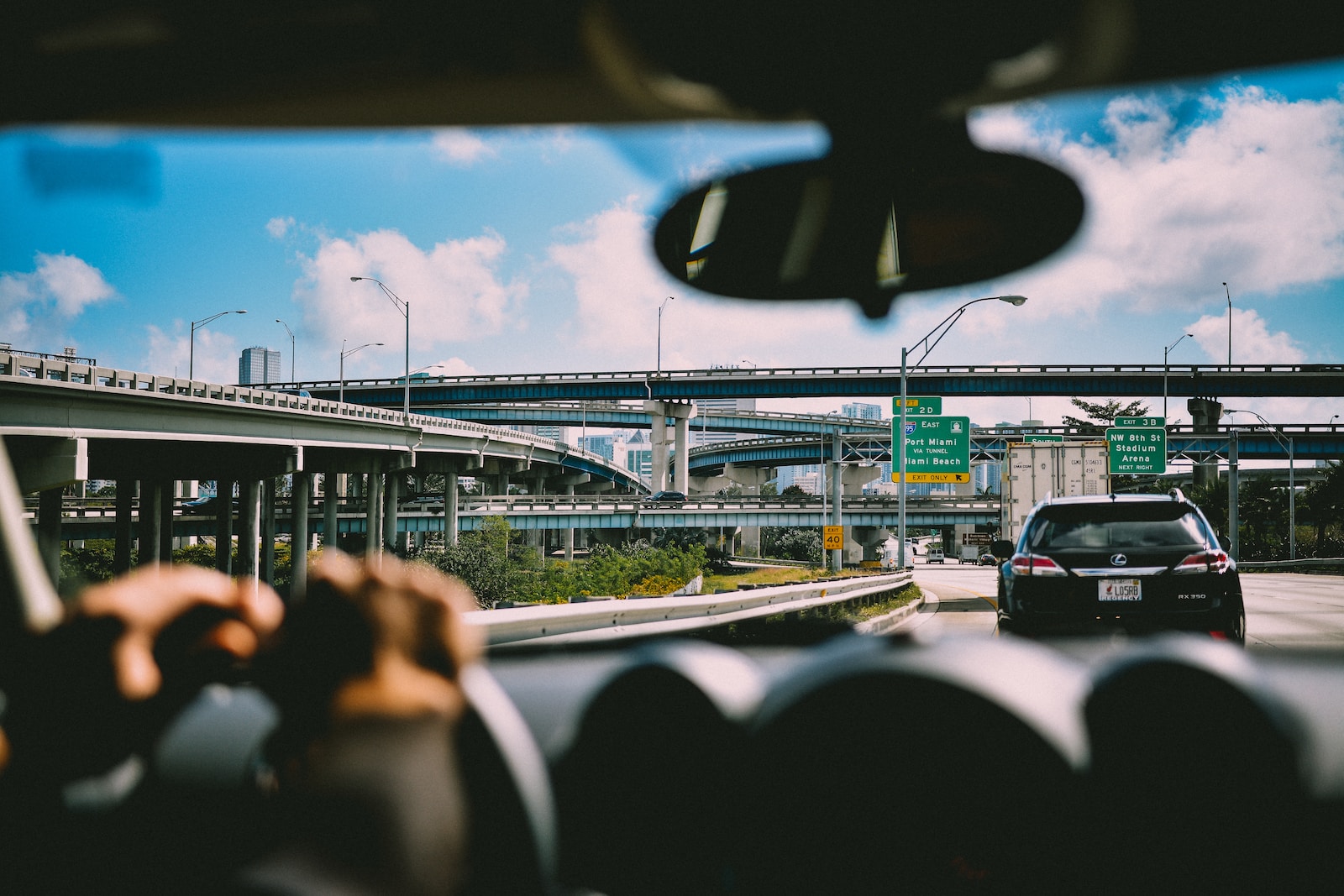 person sitting on vehicle near car and bridge at daytime, Injury Protection